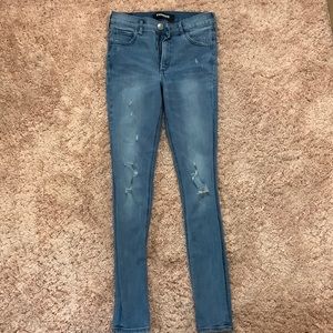 Woman’s express high rise ripped skinny jeans